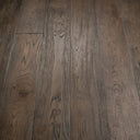 Distressed black engineered wood flooring—dark boards with knots and natural grain