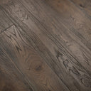 Distressed black engineered wood flooring detail—dark plank seams and swirl grain
