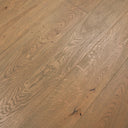 Distressed engineered wood plank flooring with scattered marks and plank seams