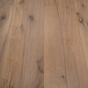 Distressed engineered wood flooring planks with long seams, knots, light grain
