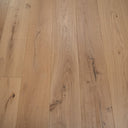 Light oak engineered wood flooring with visible grain lines, knots, and hand-scraped marks