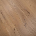 Engineered hardwood planks with light oak color, pronounced grain, and dark knot streaks