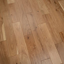 Engineered oak-toned wood flooring planks with visible wood grain and seams