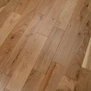 Engineered oak-toned wood flooring planks with natural knots and tight joints