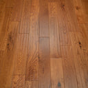 Golden engineered wood flooring, hand-scraped texture with long plank boards.