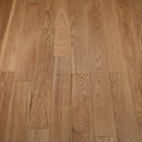 Engineered wood flooring boards in warm light brown showing natural wood grain detail