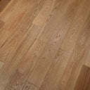 Engineered wood flooring in warm light brown with staggered plank seams and wood-grain pattern