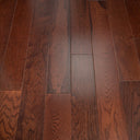 Walnut stained engineered wood flooring planks with knots visible, staggered rows
