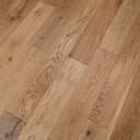Light brown engineered wood flooring planks with knots and varied grain patterns