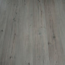 Clay grey SPC vinyl flooring with plank seams and detailed wood-grain pattern