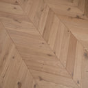 Light oak chevron parquet engineered wood flooring showing diagonal plank seams
