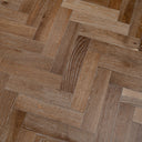 Engineered herringbone wood flooring in smoked light-brown with clear plank grain