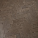 Engineered herringbone wood flooring in gunmetal grey, straight plank edges close-up
