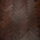 Dark walnut herringbone parquet wood flooring with varied plank grain and knots