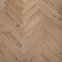 Unfinished engineered herringbone wood floor with visible knots and linear plank grain