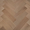Engineered herringbone wood flooring, pale oak planks with visible grain and seams