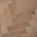 Engineered herringbone wood flooring, light beige oak planks in repeating herringbone