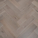 Engineered herringbone wood flooring, brushed white-toned planks with visible wood grain