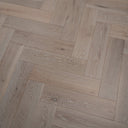 Engineered herringbone wood flooring with brushed white look and linear wood-grain pattern