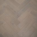 Engineered herringbone flooring, light grey brushed wood-look boards with seams
