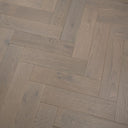 Engineered herringbone flooring, light grey oak-style planks with brushed grain