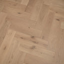 Pale oak engineered herringbone flooring detail showing wood grain and plank joins