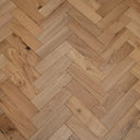 Light natural herringbone engineered wood flooring showing plank grain and knots