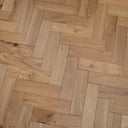 Natural engineered herringbone wood floor with varied oak-toned plank patterns