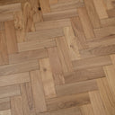 Natural engineered herringbone wood flooring with light oak planks and visible grain