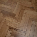 Engineered herringbone wood flooring, mixed warm oak tones in chevron pattern