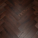 Engineered herringbone wood flooring with dark walnut tones and natural woodgrain texture