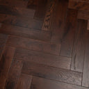 Engineered herringbone wood flooring, dark walnut stain, plank boards with visible grain