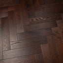 Engineered herringbone wood flooring with dark walnut stain and brushed lacquer surface texture