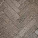 Gunmetal grey herringbone engineered wood flooring in brushed matte plank layout
