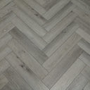 Pearl grey herringbone vinyl flooring showing alternating plank seams and subtle woodgrain