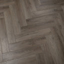 Misty smoked SPC vinyl flooring with herringbone woodgrain pattern, light gray
