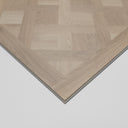 Glacier white SPC flooring panel corner with beveled border and parquet pattern