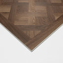 Caramel brown parquet floor panel corner with chevron wood pattern and beveled white edge