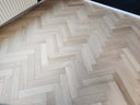 Engineered oiled herringbone wood flooring pattern, light wood with plank texture