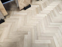 Engineered oiled herringbone wood flooring, light oak tone with staggered plank layout