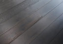 Jet black engineered wood flooring planks, diagonal angle view