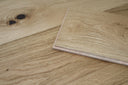 Natural engineered wood flooring plank edge detail with visible layered construction.