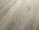Brushed oiled light oak wood flooring with visible knots and grain, long planks