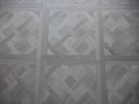 Silver grey parquet-pattern floor tile panel with visible grid seams