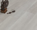Vinyl plank flooring with built-in underlay, light wood-look planks close-up