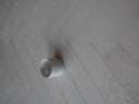White brushed matte engineered wood herringbone flooring with visible plank texture