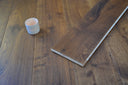 Engineered wood flooring board laid with installed planks, warm brown oiled look