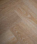 Honey oak herringbone SPC vinyl flooring with embossed plank texture