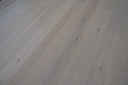 White oiled engineered wood flooring planks, visible grain and knots